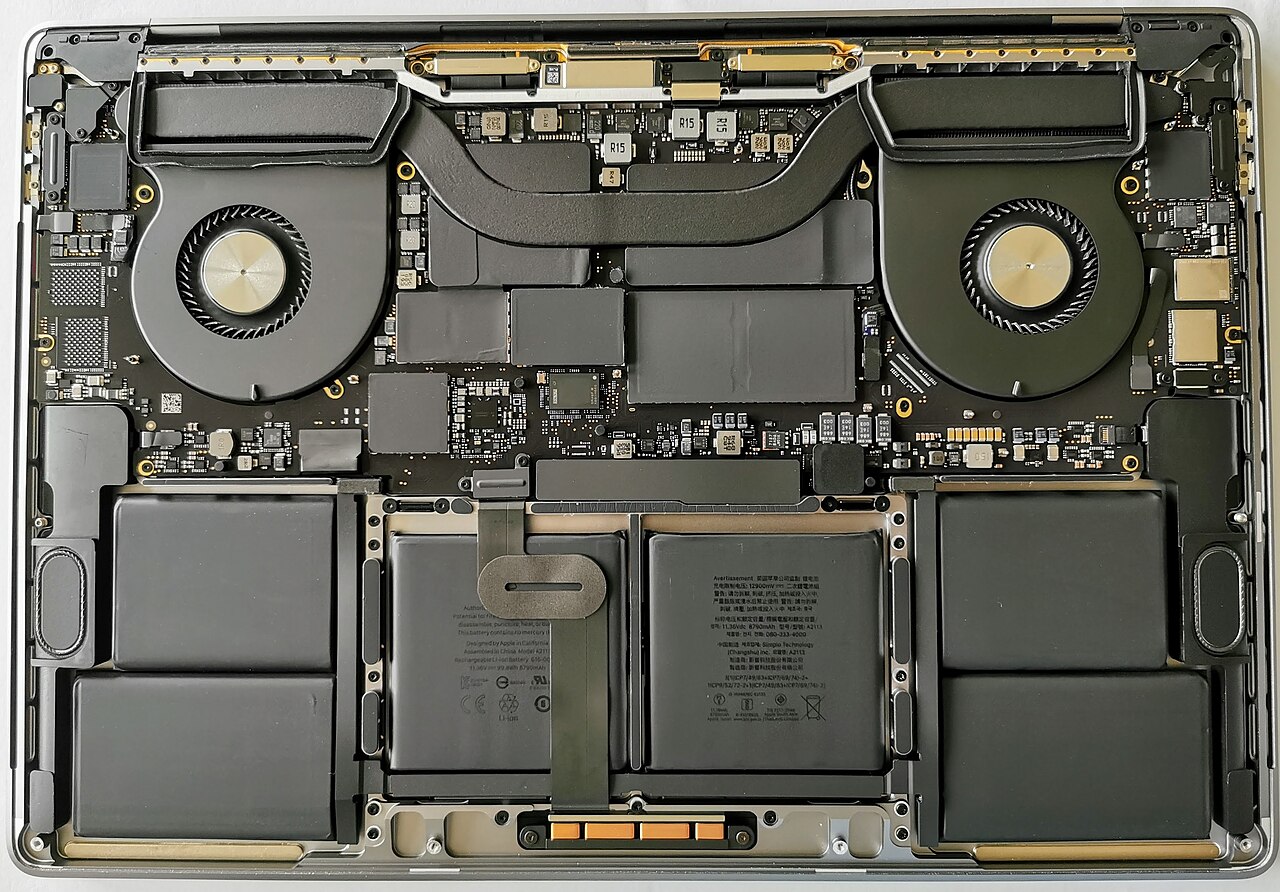 The inside of a laptop showing its battery, fans and cooling assembly